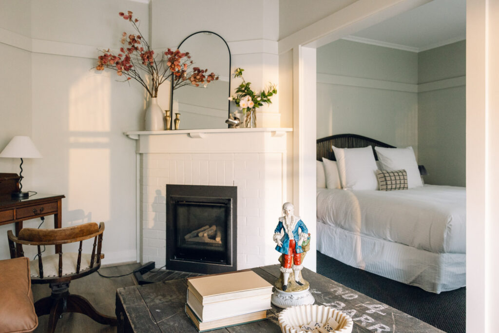 Heritage Suite living area with fireplace and adjoining bedroom at Links House