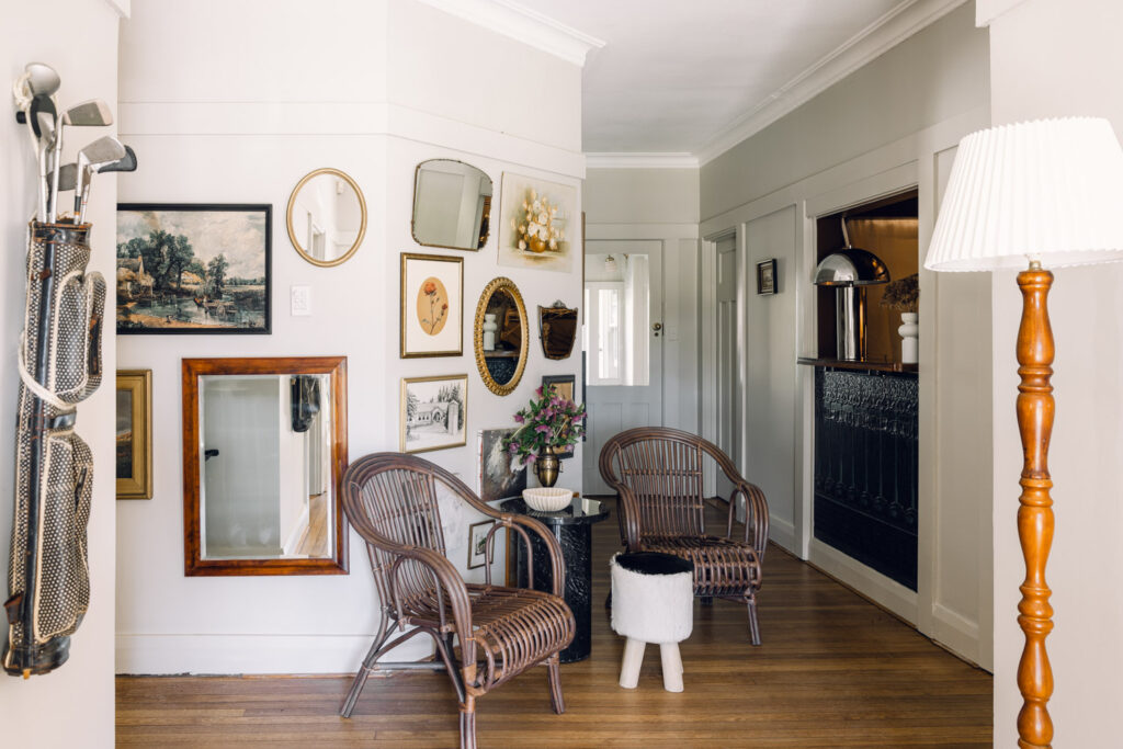 Bright hallway with framed artwork and decorative furnishings at Links House Bowral