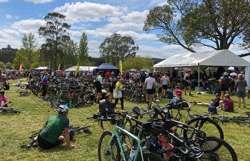Cyclists and parked bikes at the Bowral Classic Event Village in Loseby Park
